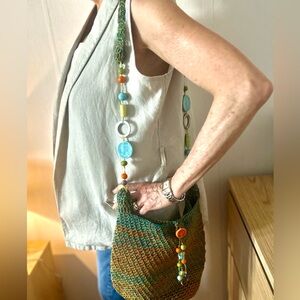 Hand woven mochila bag with beaded handle